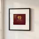 Elegant framed poster of The Brown Palace Hotel hanging on a white wall, with warm lighting and subtle shadows highlighting its high-quality print.