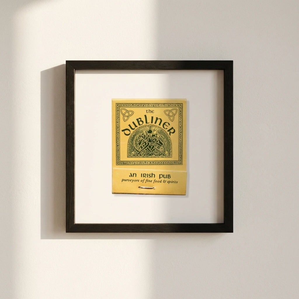Full-view of The Dubliner framed poster mounted on minimalist white wall with warm natural light, emphasizing design and construction quality.