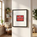 Framed 'The Dutch NYC' poster on a white wall in a cozy living room, illuminated by natural light, showcasing high-quality paper finish and black frame.