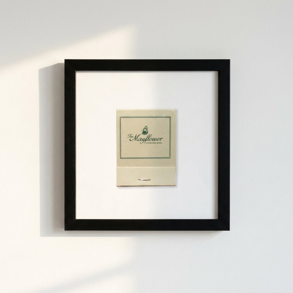 Close-up of 'The Mayflower' framed print with textured frame and detailed paper, in a cozy environment with warm natural light.