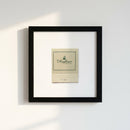 Close-up of 'The Mayflower' framed print with textured frame and detailed paper, in a cozy environment with warm natural light.