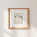 Full view of Tiny’s Framed Print mounted on a white wall in a warmly lit living space, highlighting the textured frame and print details.