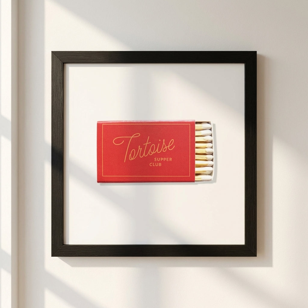 Lifelike image of the Tortoise Supper Club framed print mounted on a white wall in a cozy setting, highlighting textures and natural light.