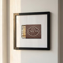 Framed Via Carota print hanging on a white wall in a cozy natural setting with soft natural light, showcasing textured paper and crisp edges.