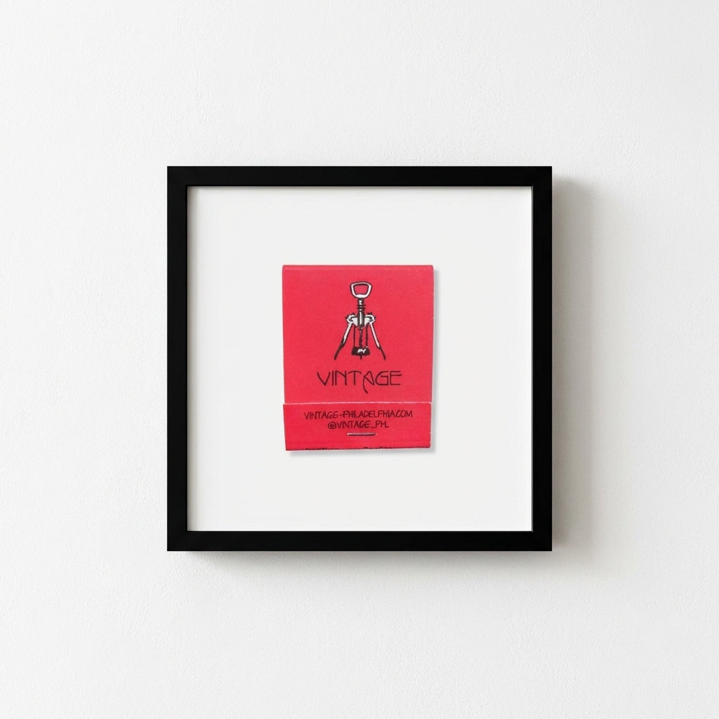 Crisp view of vintage poster in red oak frame on white wall, in a warm, inviting environment with soft natural light.
