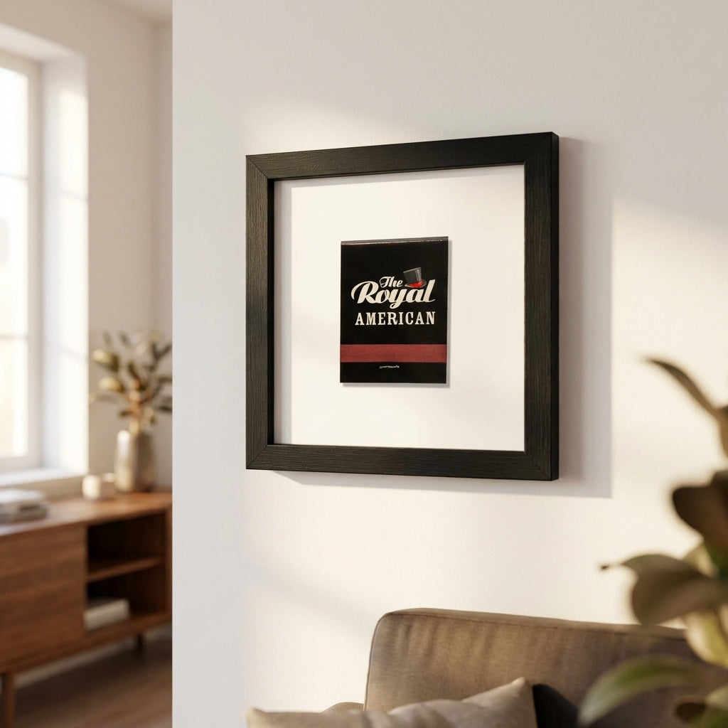 High-resolution shot of 'The Royal American' framed print in a welcoming living room with white wall background and warm natural light.